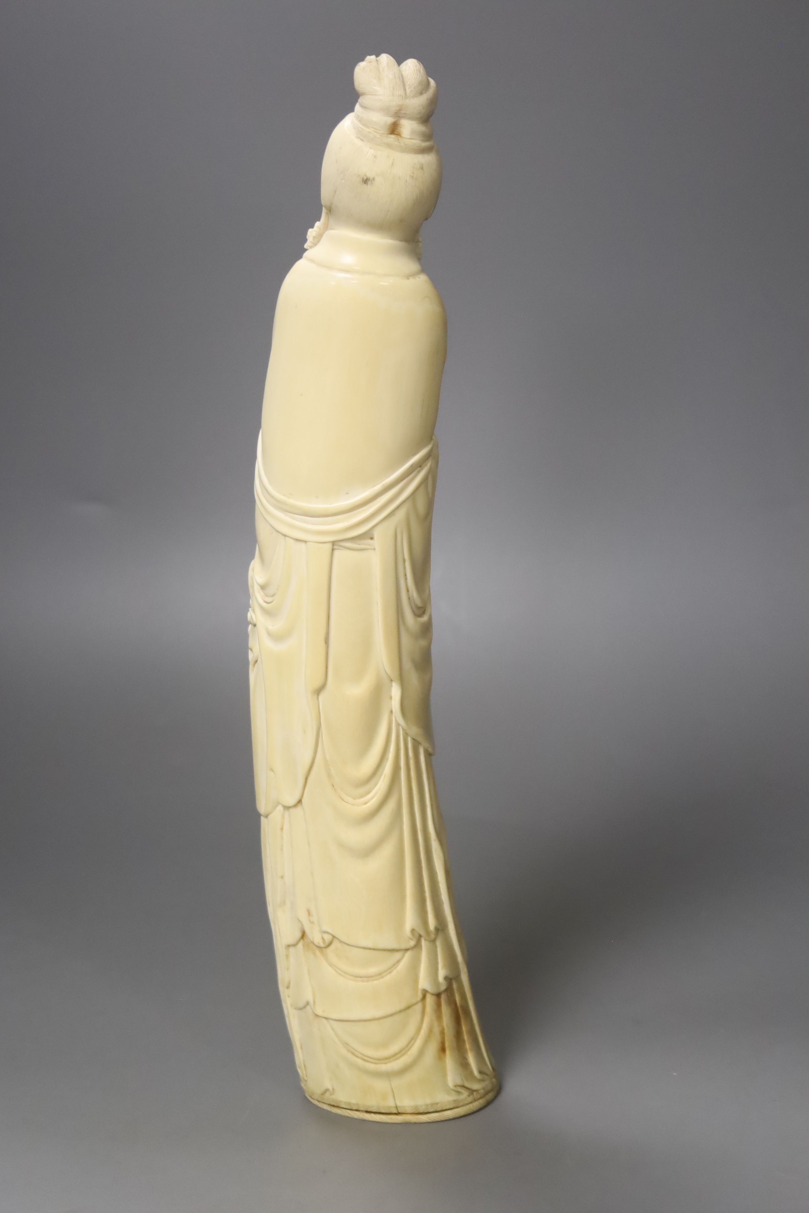 A Chinese ivory carving of a He Xiangu, early 20th century, height 34cm